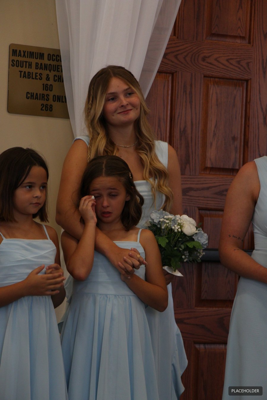 Two flower girls at the ceremony doors